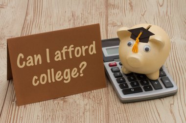 A golden piggy bank with grad cap, card and calculator on wood b clipart