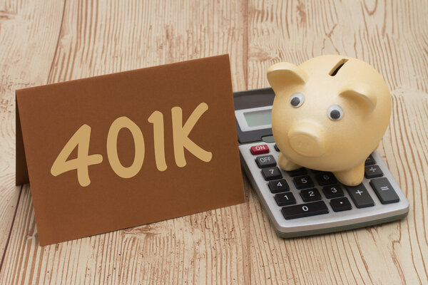 Having a 401k plan, A golden piggy bank, card and calculator on 
