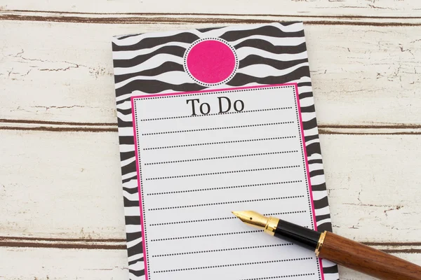 Una libreta y un bolígrafo sobre fondo de madera envejecida con texto To Do a —  Fotos de Stock