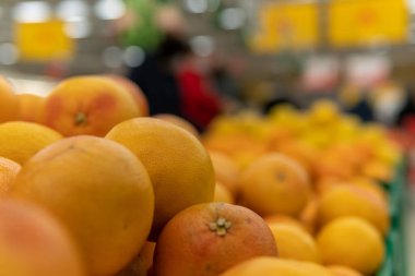 Süpermarketin tezgahında taze greyfurtlar var..