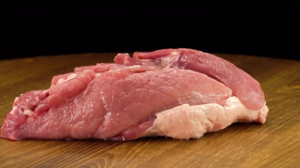 Ein Stück rohes, frisches Schweinefleisch auf einer Holzoberfläche — Stockvideo