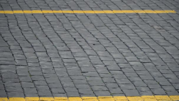 Paving stones on the square on which people are walking. — Vídeos de Stock