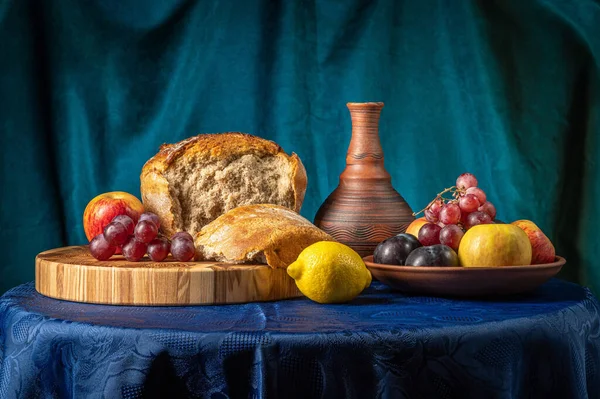 Натюрморт с кувшином, фруктами и хлебом. — стоковое фото