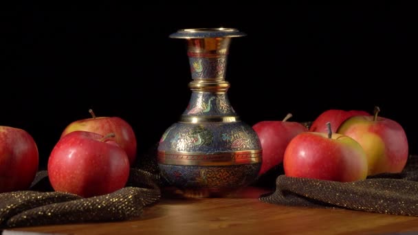 Red-yellow apples and metal vase on black background — Stock Video