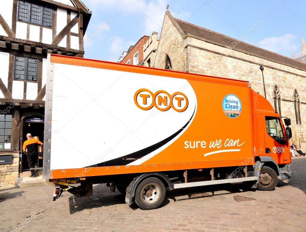 Lincoln, UK - April 9, 2015: TNT truck delivery in city centre of Lincoln, Lincolnshire, England. TNT is a famous international courier delivery services company with headquarters in Hoofddorp, Netherlands.