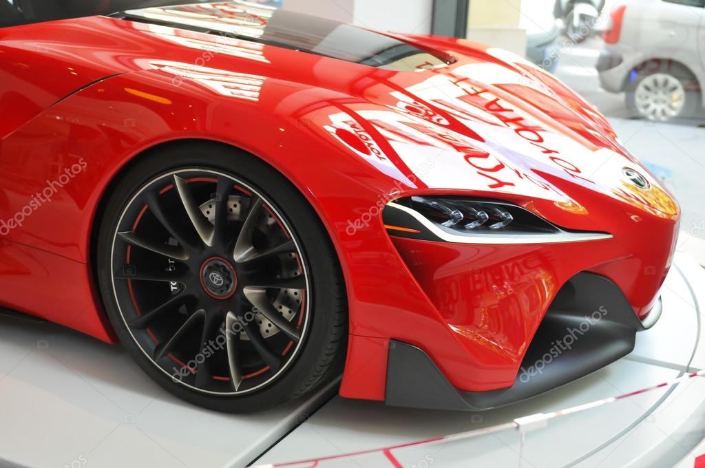 Paris, France - July 8, 2015: Detail of red Toyota modern car displayed in window shop on Champs Elysees in Paris, France