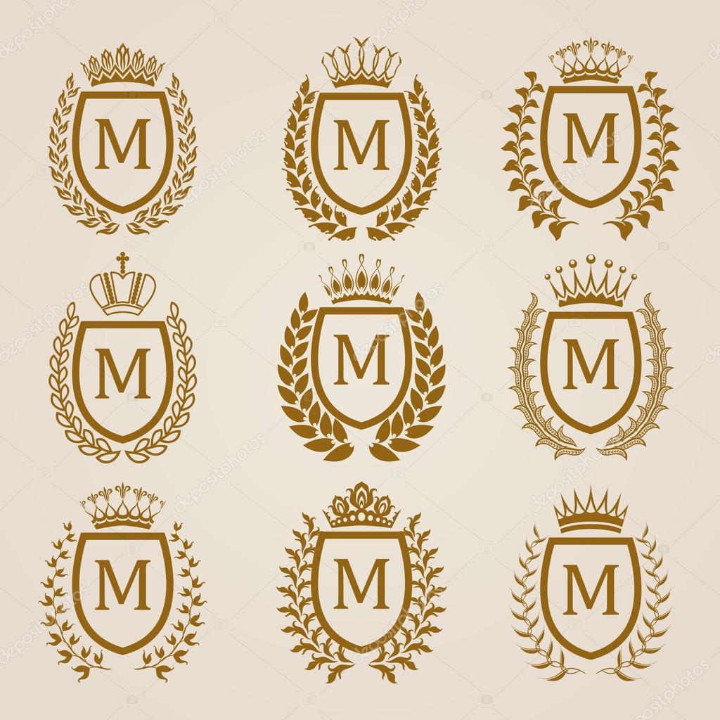 Set of luxury golden shields with laurel wreaths, crowns. Royal heraldic elements, emblems, icons, symbols, labels, badges, blazons, monograms for web, page design. Vector illustration EPS 8