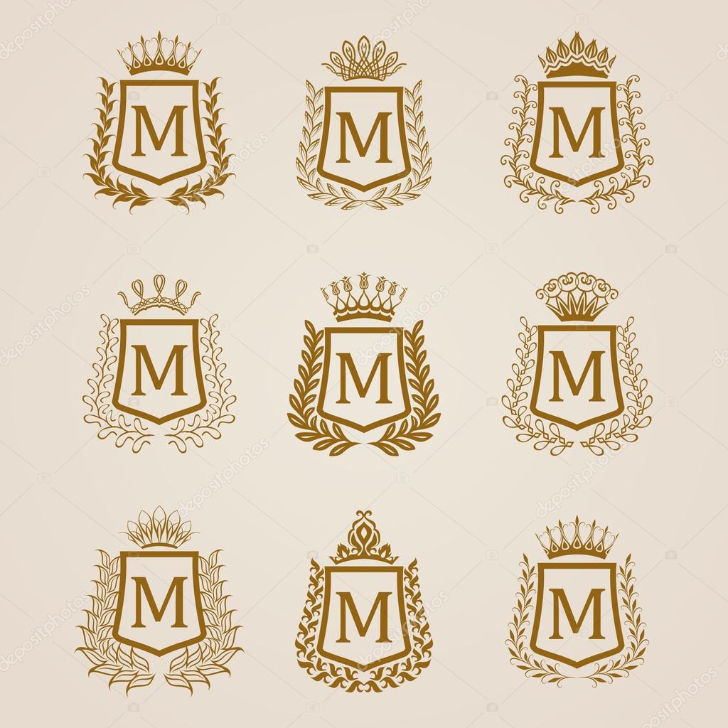 Set of luxury golden shields with laurel wreaths, crowns. Royal heraldic elements, emblems, icons, symbols, labels, badges, blazons, monograms for web, page design. Vector illustration EPS 8