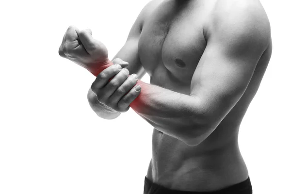 Dolor en la mano. Cuerpo masculino muscular. Guapo culturista posando en el estudio. Aislado sobre fondo blanco con punto rojo — Foto de Stock