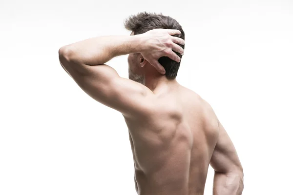 Homem muscular com uma dor de cabeça isolada no fundo branco — Fotografia de Stock