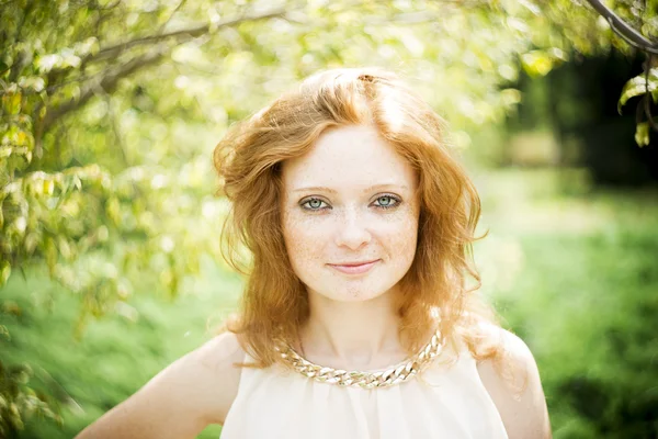 Portrait of redhead girl with blue eyes on nature — Stock Photo, Image