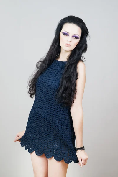 Portrait of a beautiful young woman on a gray background — Stock Photo, Image