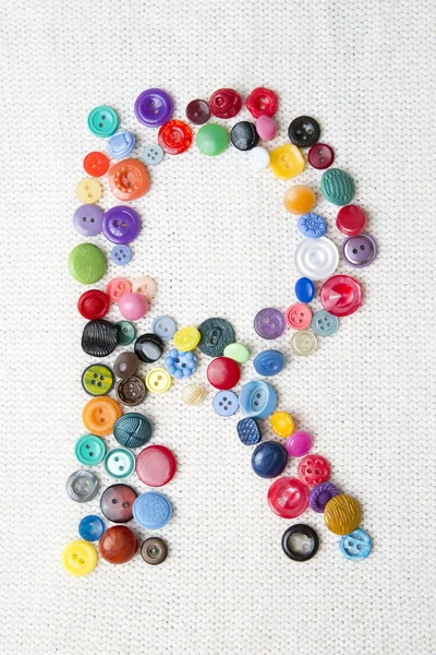 Letter R of the alphabet of buttons of various shapes and colors — Stock Photo, Image