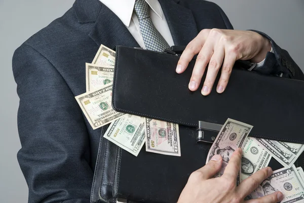 Businessman with a briefcase full of money in the hands of — Stock Photo, Image