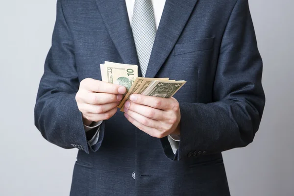 Businessman with money in studio — Stock Photo, Image