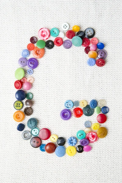 Letter G of the alphabet of buttons of various shapes and colors — Stock Photo, Image