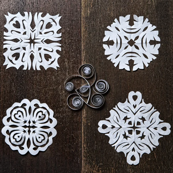 Snowflakes out of paper on wood background — Stock Photo, Image