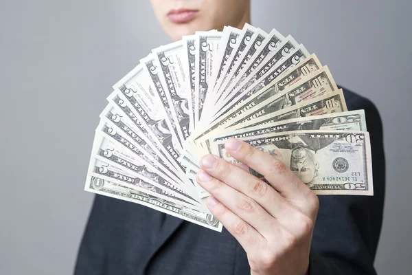 Businessman with money in studio — Stock Photo, Image