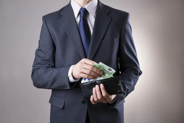 Uomo d'affari con soldi in borsa in mano — Foto Stock
