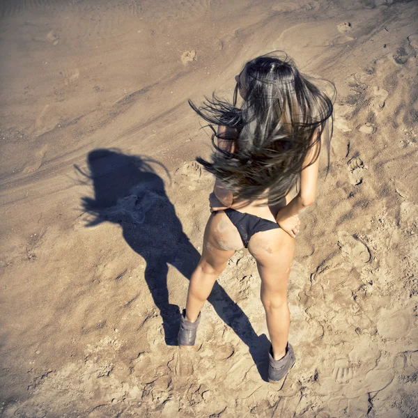 Beautiful woman sunbathing topless on a beach — Stock Photo, Image