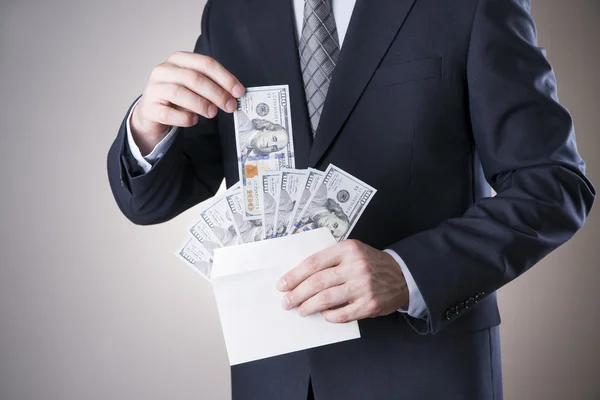 Businessman with money in studio. Corruption concept — Stock Photo, Image