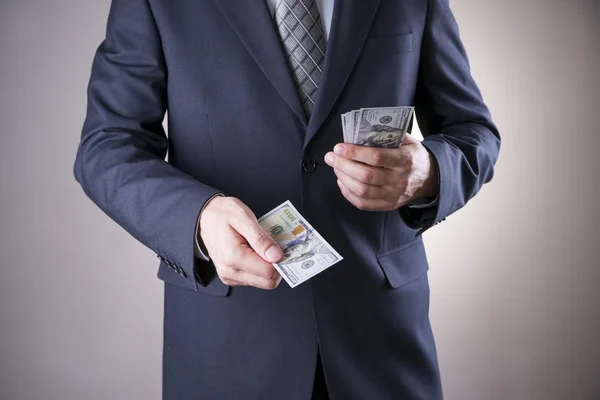 Businessman with money in studio. Corruption concept — Stock Photo, Image