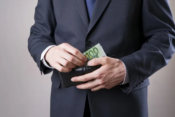 Businessman with money in studio. Corruption concept — Stock Photo, Image