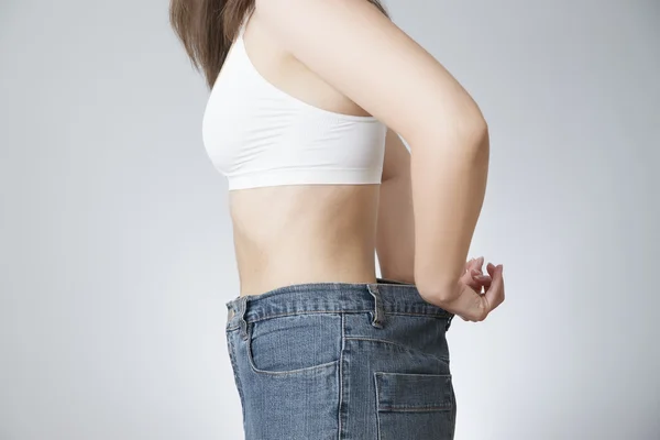 Young woman in jeans of large size, concept of weight loss — Stock Photo, Image