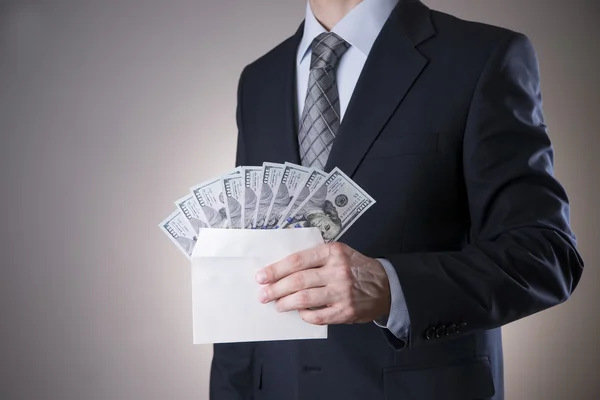 Businessman with money in studio. Corruption concept. Hundred dollar bills — Stock Photo, Image