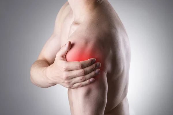 肩の痛みを持つ男。人間の体の痛み ロイヤリティフリーのストック画像