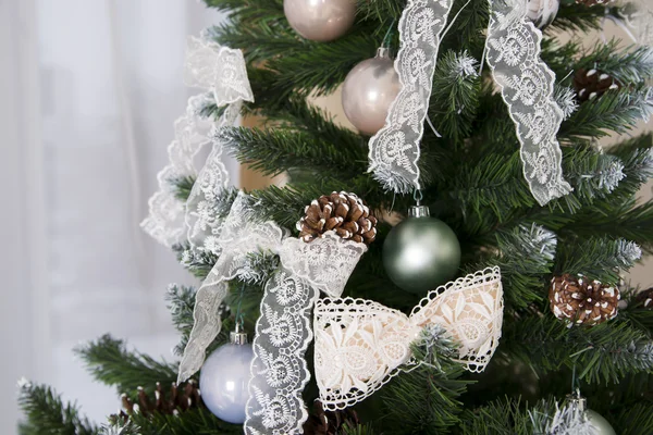 Shiny Christmas balls hanging on pine branches — Stock Photo, Image