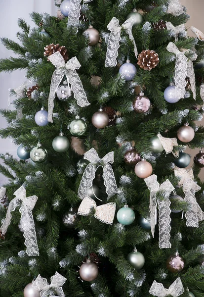 Shiny Christmas balls hanging on pine branches — Stock Photo, Image