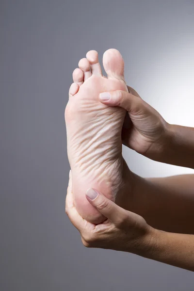 Pain in the foot. Massage of female feet — Stock Fotó