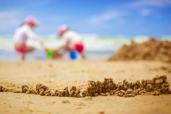 Sandy beach with blur sea on background — Stock Photo, Image
