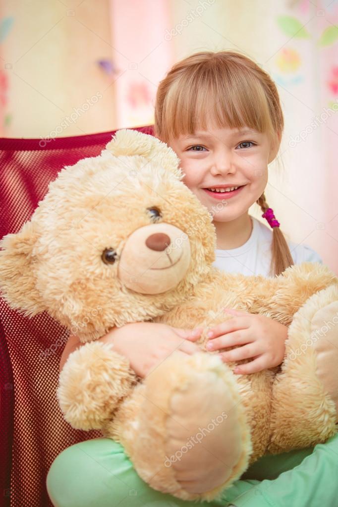 girl hugging teddy bear