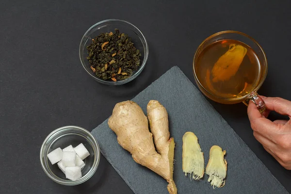 Health remedy foods for cold and flu relief with ginger and tea on a black background. Top view. Foods That Boost the Immune System.