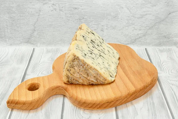 Queso Fourme dAmbert sobre tabla de cortar de madera —  Fotos de Stock