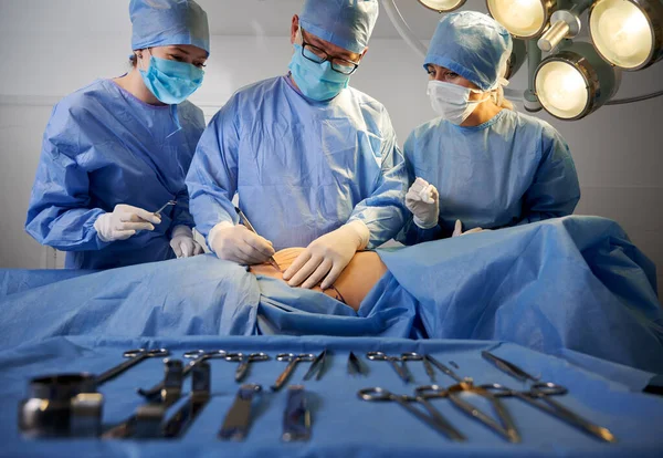 Grupo Médicos Con Guantes Estériles Mascarillas Protectoras Haciendo Cirugía Plástica —  Fotos de Stock