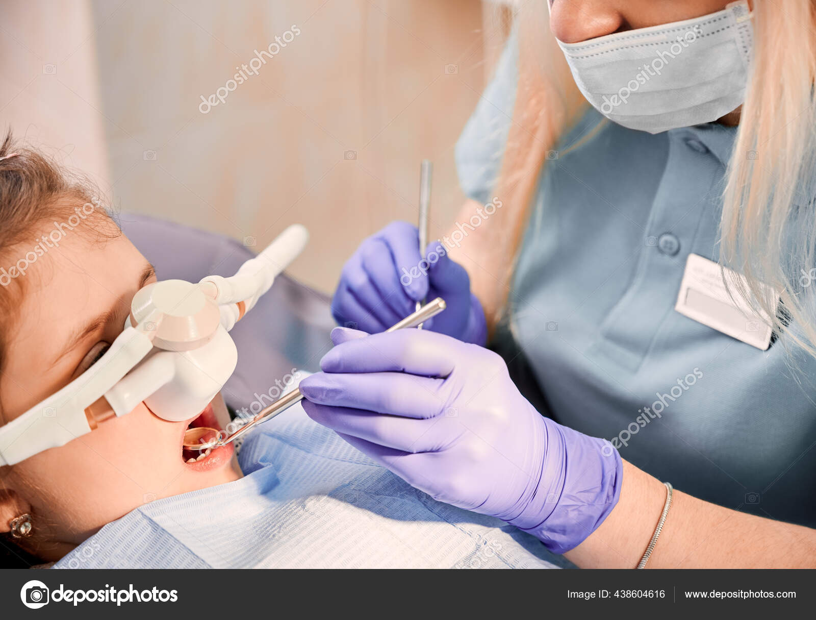 Female Dentist Checking Child Teeth Dental Explorer Mirror While Girl