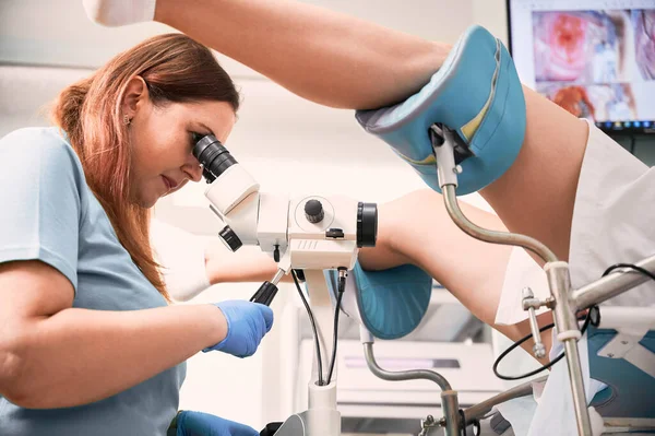 Vista Lateral Del Médico Que Usa Colposcopio Mientras Examina Una —  Fotos de Stock