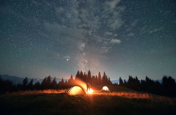 Fantastyczny Widok Nocne Gwiaździste Niebo Nad Trawiastym Wzgórzem Oświetlonymi Namiotami — Zdjęcie stockowe
