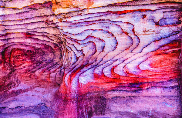 Red Rock Abstract Petra Jordan  Built by the Nabataens in 200 BC to 400 AD.  Rose Red canyon walls create many abstracts close up.  Inside the Tombs, the rose red can become blood red.  Reds are created by magnesium in sandstone.