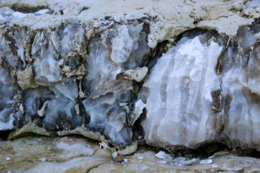 Farklı renkte kuvars kayaları. Gri, beyaz, turuncu kuvars depozitoları. Çeşitli taş birikintilerinde ve farklı kaya katmanlarında kalipdonik çeşitlilikte işlenmemiş yarı değerli taşlar..