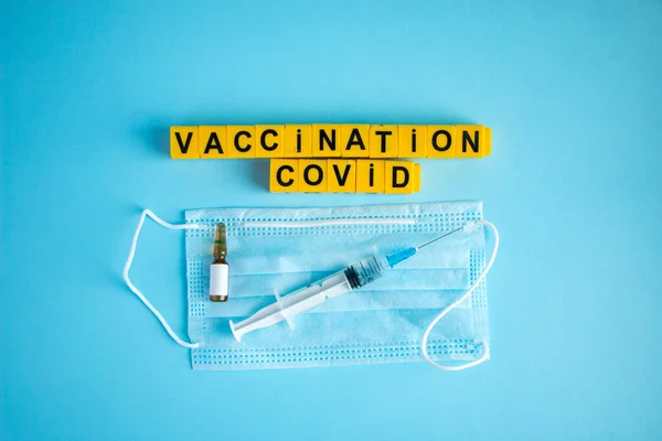 Various medicines on a blue background for Vaccination against  Corona Virus. Concept of fight against coronavirus, vaccination, immunization, treatment to  Covid 19 Corona Virus infection.