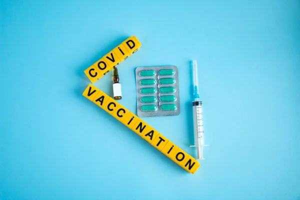 Various medicines on a blue background for Vaccination against  Corona Virus. Concept of fight against coronavirus, vaccination, immunization, treatment to  Covid 19 Corona Virus infection.