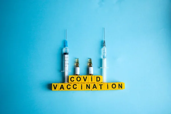 Various medicines on a blue background for Vaccination against  Corona Virus. Concept of fight against coronavirus, vaccination, immunization, treatment to  Covid 19 Corona Virus infection.