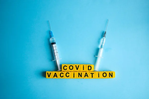 Various medicines on a blue background for Vaccination against  Corona Virus. Concept of fight against coronavirus, vaccination, immunization, treatment to  Covid 19 Corona Virus infection.