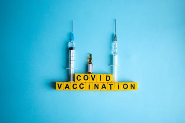 Various medicines on a blue background for Vaccination against  Corona Virus. Concept of fight against coronavirus, vaccination, immunization, treatment to  Covid 19 Corona Virus infection.