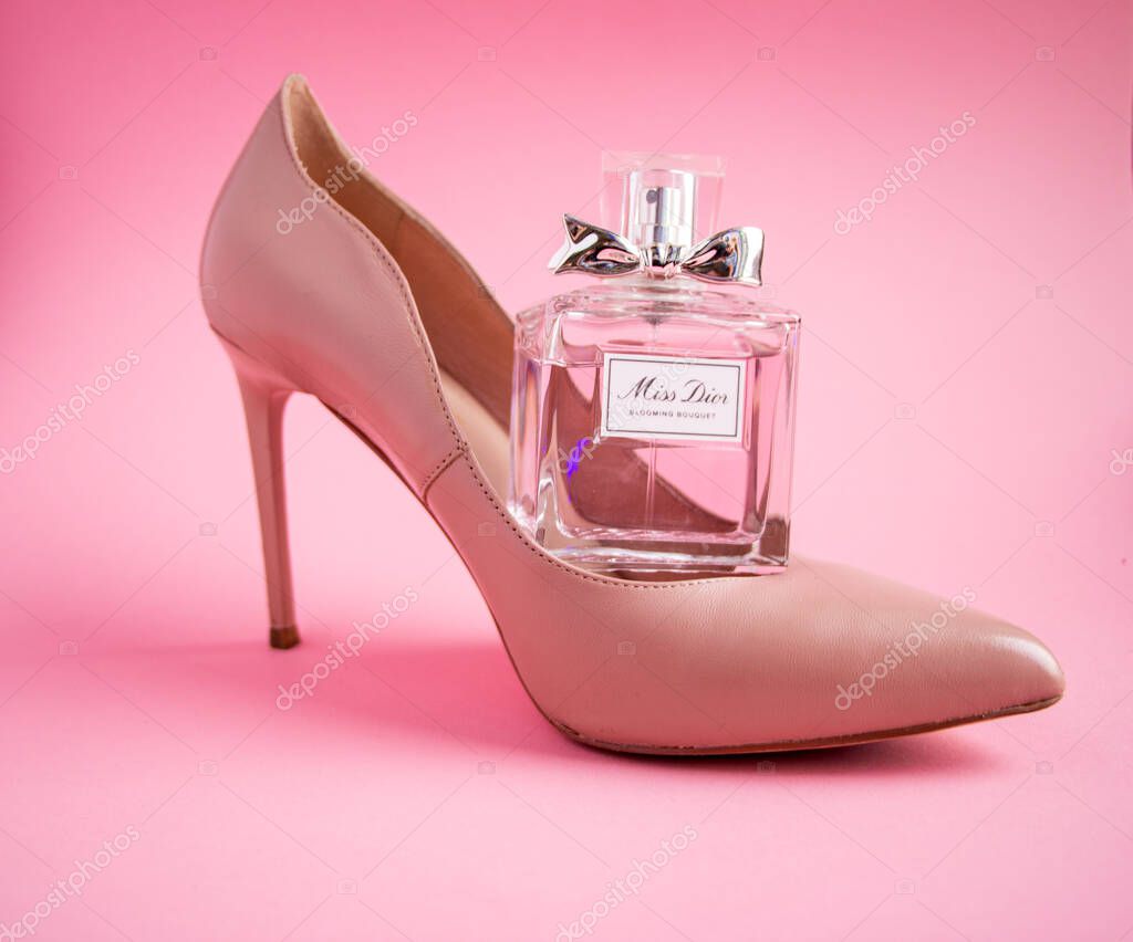 YOSHKAR-OLA, RUSSIA, JANUARY 29, 20201: glass bottle with delicate luxury perfume Miss Dior on a pink background.