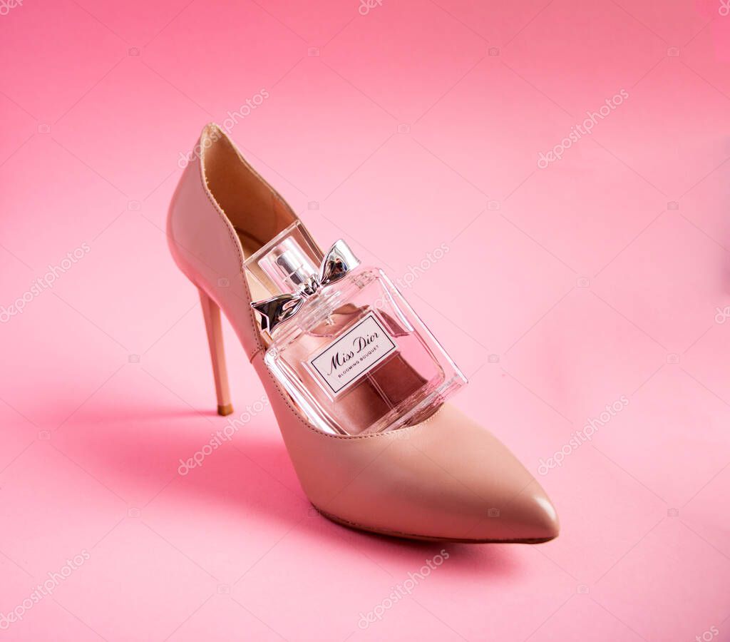 YOSHKAR-OLA, RUSSIA, JANUARY 29, 20201: glass bottle with delicate luxury perfume Miss Dior on a pink background.